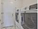 Laundry room with a washer and dryer, and access to the door at 4627 56Th E Dr, Bradenton, FL 34203