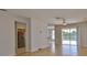 Open-concept living room flows to kitchen and features sliding glass doors to the pool at 4627 56Th E Dr, Bradenton, FL 34203