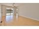 Open living room with wood flooring leads to a patio overlooking the pool area at 4627 56Th E Dr, Bradenton, FL 34203
