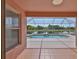 Covered patio overlooking a screened pool and tranquil lake at 4627 56Th E Dr, Bradenton, FL 34203