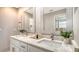 Bright bathroom boasts a double sink vanity with speckled granite countertops and decor at 4812 Greywood Ln, Sarasota, FL 34235