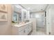 Bright bathroom with double sink vanity, speckled granite countertops, and walk-in shower at 4812 Greywood Ln, Sarasota, FL 34235