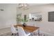 Chic dining room featuring modern lighting fixture and a pass-through to the kitchen at 4812 Greywood Ln, Sarasota, FL 34235