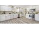 Bright kitchen features stainless steel appliances, white cabinets and speckled granite countertops at 4812 Greywood Ln, Sarasota, FL 34235