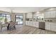 Bright eat-in kitchen with stainless steel appliances, white cabinets, and a pool view at 4812 Greywood Ln, Sarasota, FL 34235