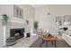 Cozy living room featuring a tiled fireplace with gas logs, neutral paint, and modern furniture at 4812 Greywood Ln, Sarasota, FL 34235