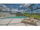 The pool has comfortable lounge chairs under a screened enclosure at 4812 Greywood Ln, Sarasota, FL 34235