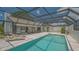 This is a beautiful screened-in pool area surrounded by a deck and patio at 4812 Greywood Ln, Sarasota, FL 34235