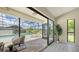 Relaxing screened-in patio with a lounge chair overlooking the sparkling pool and lush backyard at 4812 Greywood Ln, Sarasota, FL 34235