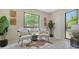 Comfortable sitting area with bright windows, modern chairs, and accent decor at 4812 Greywood Ln, Sarasota, FL 34235