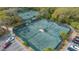Aerial view of community tennis courts, lit for nighttime play at 4812 Greywood Ln, Sarasota, FL 34235