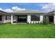A well maintained backyard features green grass, a small patio, and white stucco exterior walls at 4927 Carova Way, Bradenton, FL 34211