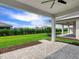 Backyard patio featuring a ceiling fan and a view of a well maintained lawn at 4927 Carova Way, Bradenton, FL 34211