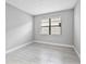 Simple bedroom with tile flooring, a single window, and neutral paint at 4927 Carova Way, Bradenton, FL 34211