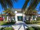 Beautiful, modern clubhouse featuring a welcoming entrance and lush tropical landscaping at 4927 Carova Way, Bradenton, FL 34211