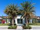 Entrance to community clubhouse surrounded by palm trees, landscaping and lush greens at 4927 Carova Way, Bradenton, FL 34211