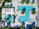 Aerial view of resort-style pool with sun loungers, umbrellas, and tropical landscaping at 4927 Carova Way, Bradenton, FL 34211