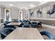 Inviting dining room featuring stylish blue chairs, neutral walls, and artwork at 4927 Carova Way, Bradenton, FL 34211