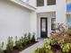 Stylish front entrance showcases a decorative glass door, landscaped walkway, and a bright exterior at 4927 Carova Way, Bradenton, FL 34211