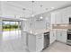 Open kitchen featuring stainless steel appliances, a large island, and easy access to the backyard at 4927 Carova Way, Bradenton, FL 34211