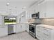 Bright kitchen featuring stainless steel appliances and views to the backyard from the kitchen sink at 4927 Carova Way, Bradenton, FL 34211