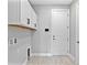Laundry room features white cabinets, tiled floor, and a convenient layout at 4927 Carova Way, Bradenton, FL 34211