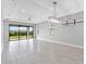Spacious living room with large sliding glass doors leading to the backyard and patio at 4927 Carova Way, Bradenton, FL 34211