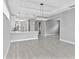 Open-concept living space with recessed lights, kitchen bar, and tiled flooring at 4927 Carova Way, Bradenton, FL 34211