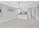 Bright, open-concept living and kitchen area with tile flooring and modern pendant lighting at 4927 Carova Way, Bradenton, FL 34211