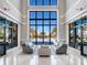 Elegant lounge area with floor to ceiling windows that overlook the pool area and tropical landscape at 4927 Carova Way, Bradenton, FL 34211