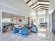 Bright lounge with high ceilings, elegant decor, and ample seating for relaxation and socializing at 4927 Carova Way, Bradenton, FL 34211