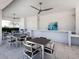 Comfortable outdoor lounge area with a kitchen space, ceiling fans and seating, ideal for entertaining or relaxing at 4927 Carova Way, Bradenton, FL 34211