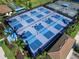Aerial view of new blue and green pickleball courts with lights and black fencing at 4927 Carova Way, Bradenton, FL 34211