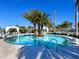 Inviting pool with lush tropical landscaping, cabanas, and lounge chairs for relaxing by the water at 4927 Carova Way, Bradenton, FL 34211
