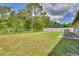Spacious backyard featuring well-kept lawn, chainlink fence and a seating area at 5530 21St Street E Ct, Bradenton, FL 34203