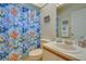 Bright bathroom featuring a fun, colorful shower curtain, ample lighting, and vanity with sink at 5530 21St Street E Ct, Bradenton, FL 34203