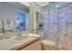 Bathroom featuring marine themed shower curtain and adjacent bedroom is visible at 5530 21St Street E Ct, Bradenton, FL 34203