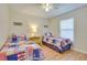 Charming bedroom featuring two twin beds, nautical decor, and a ceiling fan for comfortable living at 5530 21St Street E Ct, Bradenton, FL 34203