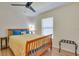 Bedroom with hardwood floors, a ceiling fan, a bed with blue bedding and a decorative pillow at 5530 21St Street E Ct, Bradenton, FL 34203