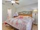 Bedroom with hardwood floors, a bed with floral bedding, and decorative lamps on side tables at 5530 21St Street E Ct, Bradenton, FL 34203