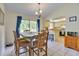 Bright dining area with views of greenery featuring a table and modern light fixture at 5530 21St Street E Ct, Bradenton, FL 34203