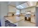 Cozy kitchen featuring light wood cabinets, stainless steel appliances, and breakfast bar at 5530 21St Street E Ct, Bradenton, FL 34203