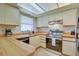 Well-lit kitchen featuring stainless steel appliances, light cabinetry, and a window above the sink at 5530 21St Street E Ct, Bradenton, FL 34203