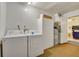 Functional laundry room with washer, dryer, storage, and easy access to other living areas at 5530 21St Street E Ct, Bradenton, FL 34203