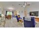 Bright living room with vaulted ceiling, tile floors, and access to the dining area at 5530 21St Street E Ct, Bradenton, FL 34203