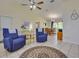 Inviting living room featuring tiled floor, cozy seating, and dining area access at 5530 21St Street E Ct, Bradenton, FL 34203