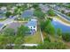 Aerial view of home showing a backyard with screened pool, green lawn, and a pond nearby at 5561 Burnt Branch Cir, Sarasota, FL 34232