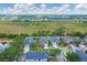 Aerial view of homes in residential area with fenced yards, mature trees and near commercial area at 5561 Burnt Branch Cir, Sarasota, FL 34232