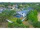 Aerial view of backyard featuring a screened pool, green lawn, and privacy fence at 5561 Burnt Branch Cir, Sarasota, FL 34232