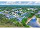 Aerial view of a residential neighborhood showing backyard screened pool and nearby pond at 5561 Burnt Branch Cir, Sarasota, FL 34232